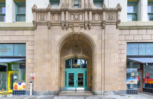 entrance with ornate architecture and teal door